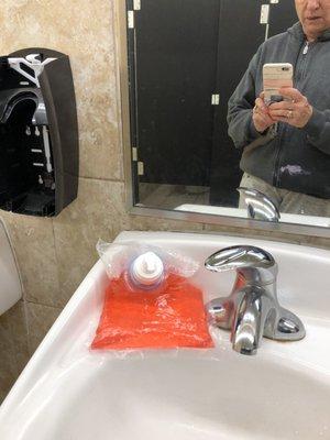 Soap laying on sink instead of in the container.