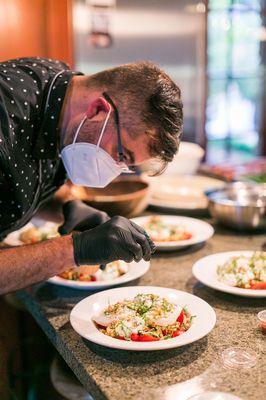 Safety first for Chef Justin as he plates away.