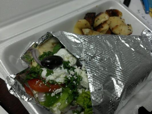 Specially made veggie gyro with side of potatoes