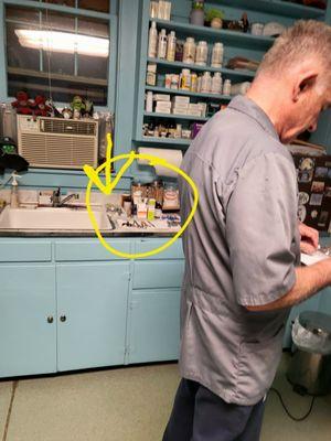 The counter is full of used needles piled on paper towels next to the sink.