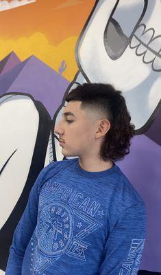 My son and his favorite barbershop mural wall