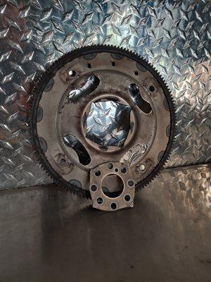 Broken flexplate. This piece connects the engine and torque converter (on the transmission) together.