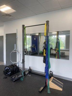 Squat rack in the gym with variety of weights.