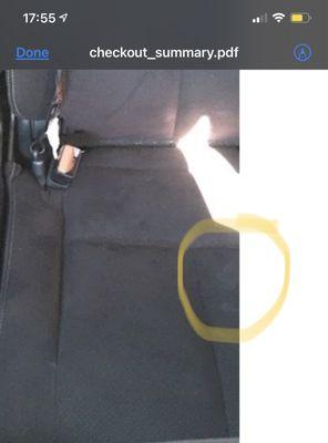 The stain in a photo Hertz emailed me when picking up the car. (The same stain they charged me to clean)