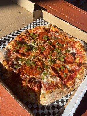 505 pizza with pepperoni, sausage, and green chilis