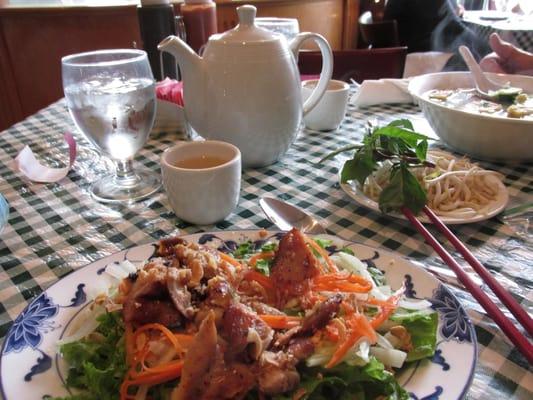 salad with chicken and pot of green tea for two