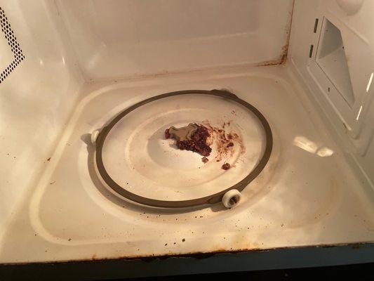 Dirty microwave with food in it.