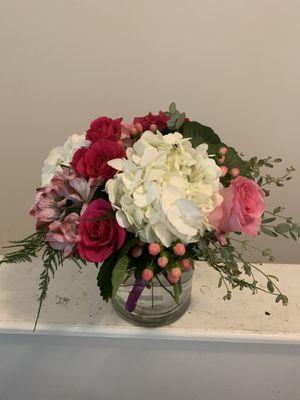 Hydrangeas, Spray Roses, Alstromeria, Hypericum, Roses, Kale, and Guinea in a glass vase.