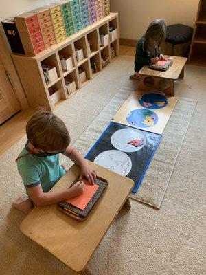 Early Childhood students work simultaneously on a Geography map making work.