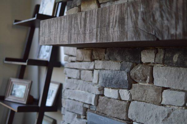 Custom stone fireplace with hand-made mantel