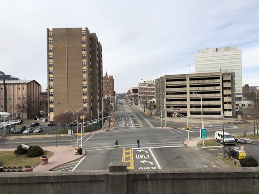 View from the station's platform, looking west from Ward St, with the municipal parking garage, and a glimpse of downtown. (12/9/2018)