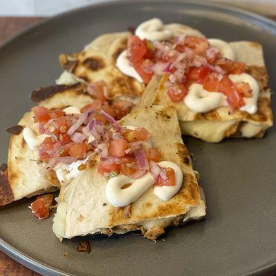 lemon butter chicken quesadilla, served with pico de Gallo, sour cream