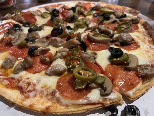 Pizza (pepperoni, black olives, mushrooms, sausage, jalapeños)