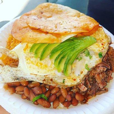 Breakfast birria plate two tortillas avocado slices on top