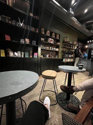 Coffee counter and book shelving, viewed from bench seating along opposite wall.