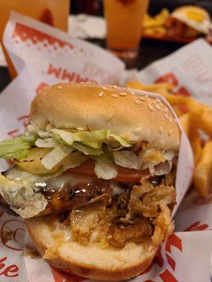 Teriyaki chicken burger with onion straws.