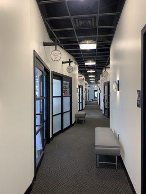 Interior hallway view of individual salon rooms