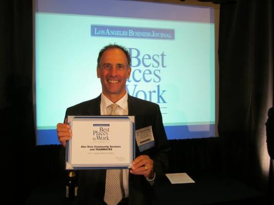 Peter Zucker, PhD, accepts "Best Places to Work" award.