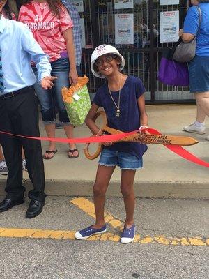 My daughter cutting the ribbon on our 10th anniversay.