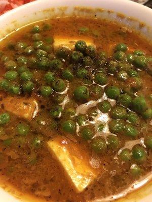 Dish of oil and peas.