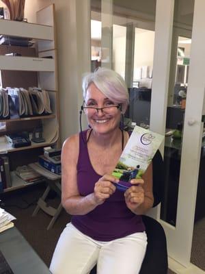 Looking vibrant in her hospice colors, Becky models our Hospice Maui brochure!