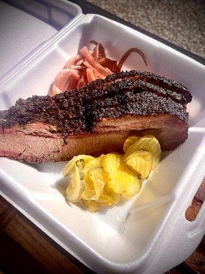 A beautiful yet simple order of Brisket, with pickles and pickles red onions on the side.