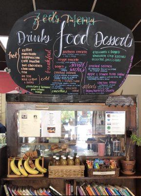 Front counter with a display of pastries & menu.