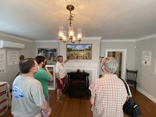 A staff explains to the visitors on the history of the parsonage