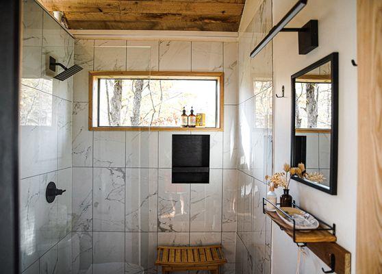 Barn door slider, custom private tile shower with forest views at Cuyuna Cove