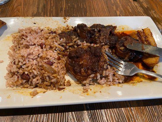 Oxtail Meal with fried plantains and rice and peas (half eaten in this picture)