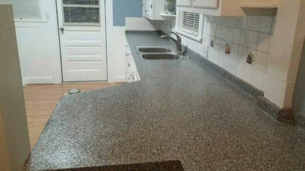 Kitchen countertop after epoxy and flake coating is applied.