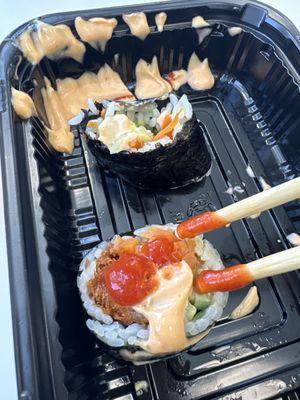 Shrimp, tempura, sushi, ready, and prepared to go in a deli case