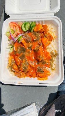 Chicken Makhani in a slightly sweet tomato base with hot sauce on the side over a very nice rice and a small salad