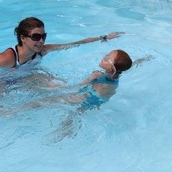 Instructor Bree's student swims confidently while she follows