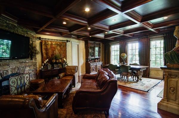 Wood grained coffer ceiling with Tuscan colored plaster walls with Fauxstone and marble top statue base enhancement.