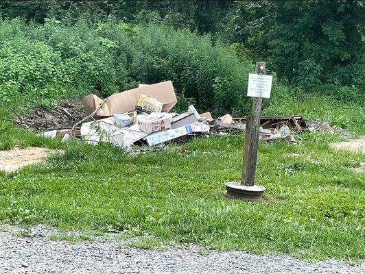 Trash pile directly across from tent site 3 and 4