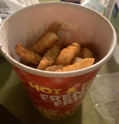 Bucket of French fries with old bay seasoning that was half full