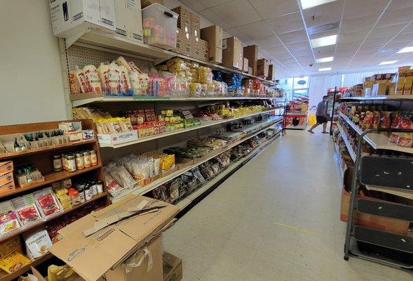 View from the back of the store towards the front in aisle 1, left side.