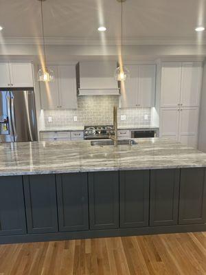 Kitchen, flooring, cabinets, tile back splash and lighting .