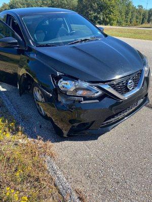 The damage to my car after my tire exploded. I didn't have a spare and my bumper was dragging on the ground.