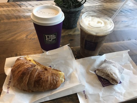 Yummy vanilla latte , cold brew coffee, breakfast croissant sandwich, and a delicious beignet