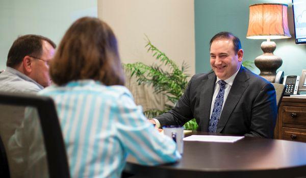 Michael Neuenschwander, CPA, CFP meeting with clients to review their wealth management and retirement strategies.