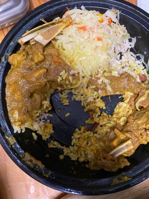 Curry goat rice peas and salad. My husband couldn't wait so as you see I couldn't get the whole pic. The food is delicious.