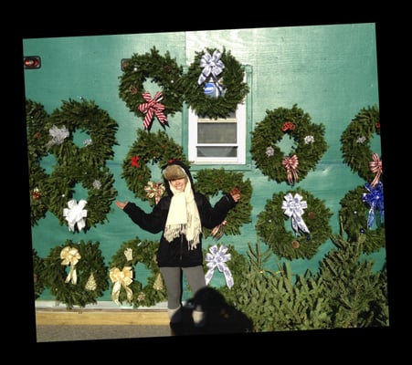 Kelly, our Master Wreath Maker, with some of her handmade Christmas wreaths.