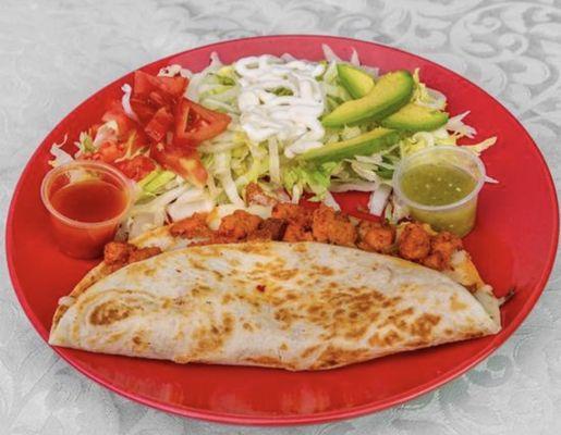 Taqueria Yolandita's Quesadilla includes: lettuce, tomatoes, sour cream, cheese, onions & sauce on the side.