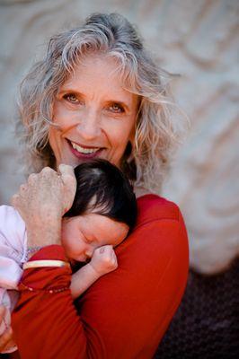 Becky, one of Conception Wellness's massage therapists, cuddling a Conception Wellness baby!