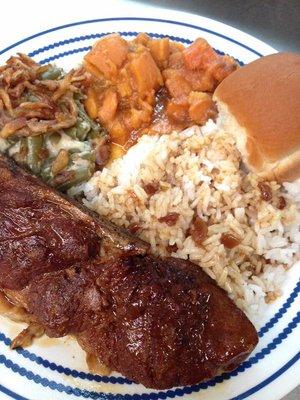 Pork roast with gravy, green bean casserole, sweet potatoes and dinner roll