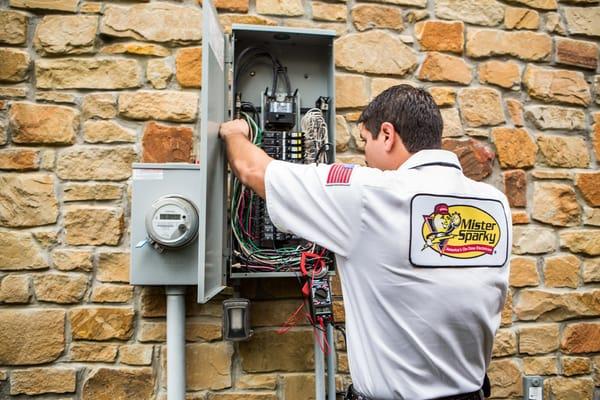 Mister Sparky fixing an electrical breaker.