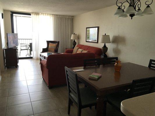 Living and dining area with large TV and full cable.