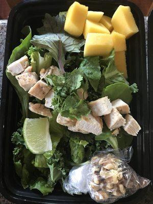 Mango walnut chicken salad with mixed super greens, cilantro & lime